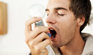 Man using an asthma inhaler